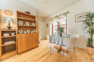 a dining room with a table and chairs at The Blue House in Portree +5 photos