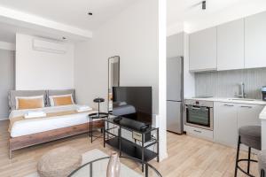 a small apartment with a bed and a kitchen at Yamas Urban Living Olympia Suites in Limassol