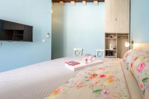 a bedroom with a bed with a table on it at Stradun View En Suite Rooms & Studio in Dubrovnik