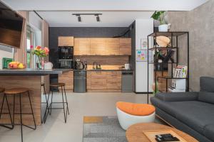 a kitchen and a living room with a couch at Premium Apartment Eleven in Zator