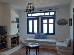 a living room with a couch and a window at Wide sea Maisonette in Agios Dimitrios