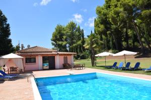 a villa with a swimming pool and a house at Αρετή in Amaliás