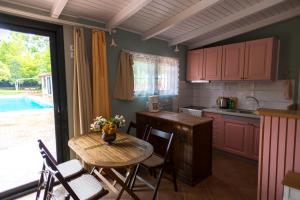 a kitchen with a table and a table and chairs at Αρετή in Amaliás