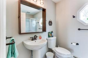 a bathroom with a sink and a toilet and a mirror at Walk to Town Charming Unit with Balcony in Bedford! in Bedford +16 photos