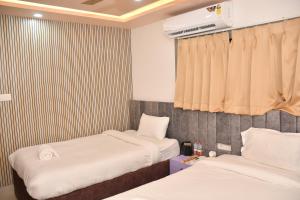 Voodi või voodid majutusasutuse Hotel Ratneswar toas