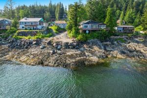 an aerial view of a house on the shore of a body of water at 6 Mi to Main St Oceanfront Cottage in Ketchikan in Ketchikan