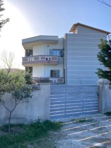 a building with a fence in front of it at Villa Kozma & Kristina in Zverneci