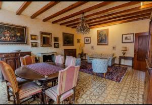 a living room with a table and chairs and a fireplace at Suite Mazzini 23 in Mantova