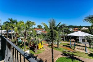 a view from a balcony of a resort with palm trees at Charmosos Studios no IL Campanario Villaggio Resort ILCJR II in Florianópolis