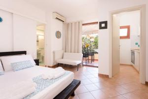 a bedroom with a bed and a table and a chair at THE THREE WAVES LUX, Olbia Mare in Olbia