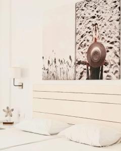 a bedroom with a bed with a picture on the wall at Aegeo Inn in Antiparos