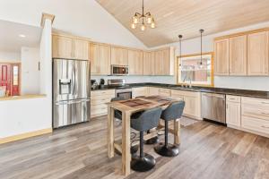 a kitchen with wooden cabinets and a wooden table at Lakeside 4BR Retreat Private, Peaceful & Scenic villa 