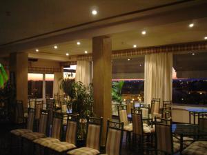 a banquet hall with chairs and tables and windows at Soltejo in Vila Nova da Barquinha