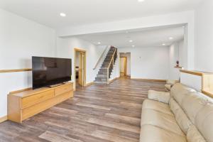 a living room with a couch and a flat screen tv at Lakeside 4BR Retreat Private, Peaceful & Scenic villa 
