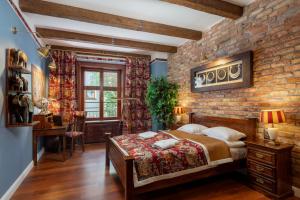 a bedroom with a brick accent wall and a bed at Old House Apartments 2 Poznań in Poznań