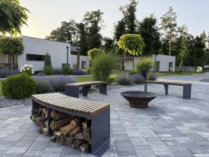 two benches and a fire pit in a courtyard at Sobi Village in Oseshchino