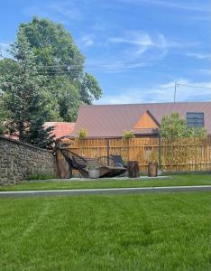 斯扎法拉瑞Apartamenty Polański Termalne Szaflary - Gorący Potok i Termy Szaflary 20 procent rabat的有篱笆的院子，院子里有一张长凳 更多55张照片