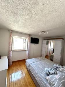 a bedroom with a large bed and a window at Old city core in Senj