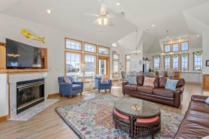 a living room with a couch and a fireplace at By Grace in Kill Devil Hills