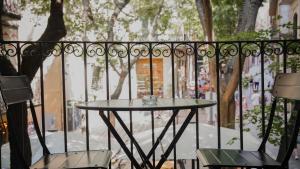 a table and two chairs on a balcony at Força Old Town in Girona