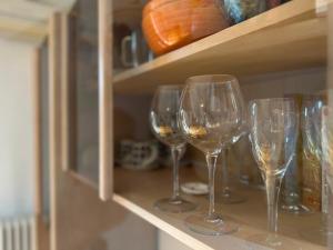a row of wine glasses sitting on a shelf at Casa Lilla in Verona