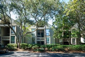 a house with trees in front of it at 1307 Pelican Watch Villa in Seabrook Island