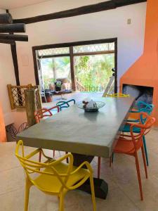 a table and chairs in a room with a fireplace at Casa com Espaço Gourmet - Mini Academia - Centro de São Sebastião in São Sebastião