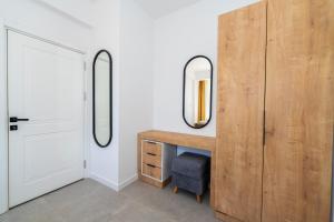 a room with a desk and two mirrors on the wall at Dede Suites Fethiye in Fethiye
