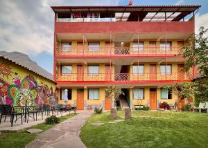 a building with a mural on the side of it at Pisac Inca Guest House in Pisac