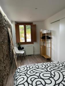 a room with a bed and a table and a chair at Adiva Casa Da Avoa in Puentedeume +43 photos