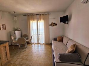 a living room with a couch and a table at Corfu Dream Holidays Villas in Glyfada