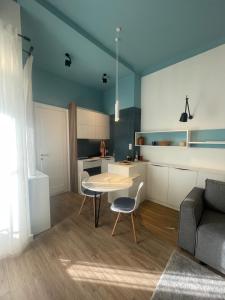 a living room with a table and a couch at Studio Melem in Novi Sad