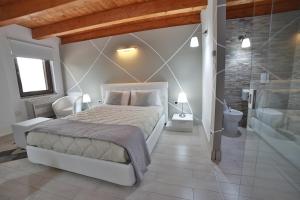 a bedroom with a large bed and a bathroom at Villa Giulia Del Cavaliere in Castrovillari
