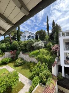 a view of the garden from the balcony of a house at Casa di Giò - Comfy Lake Como Attic in Malgrate