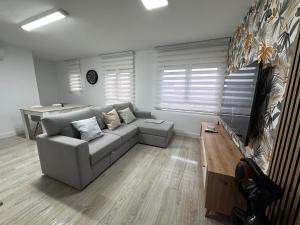 a living room with a couch and a table at Apartamentos Turísticos Las Claras 2 in Tordesillas