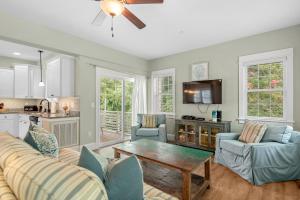 a living room with a couch and a table at Bay Breeze in Kill Devil Hills