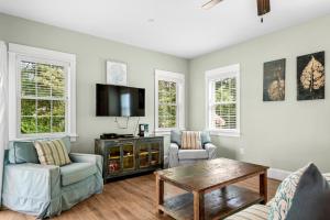 a living room with two chairs and a tv at Bay Breeze in Kill Devil Hills