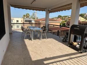 eine Terrasse mit Tisch und Stühlen auf einem Balkon in der Unterkunft Chalet encanto in Chiva