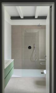 a bathroom with a shower with a glass door at Urban Living in Como