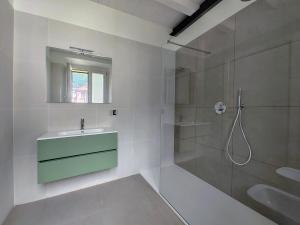 a white bathroom with a sink and a shower at Urban Living in Como
