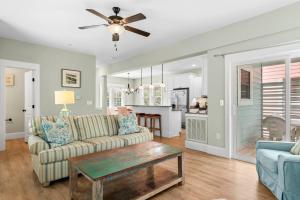 a living room with a couch and a table at Bay Breeze in Kill Devil Hills