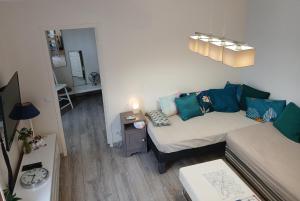 a small living room with a couch and a table at Puces de Vanves in Malakoff