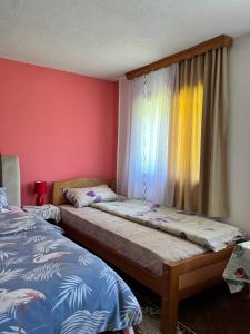 two beds in a room with a window and a bed sqor at MAGLIC in Plužine
