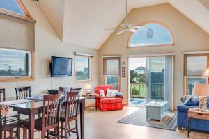 a living room with a table and chairs at Baymeadow 10 in Nags Head