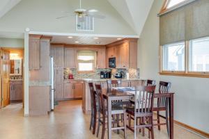 a kitchen with a table and chairs and a refrigerator at Baymeadow 10 in Nags Head +28 photos