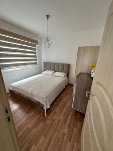 a bedroom with a large bed and a window at Two Bedrooms LongBeach SeaView Escape in Paralimni +2 photos