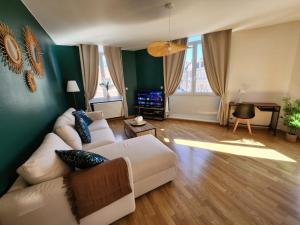 a living room with a couch and a table at Appartement de charme au centre d'Arras in Arras