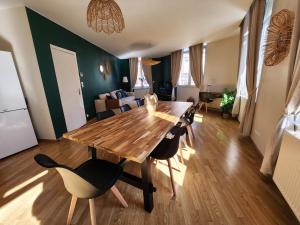 a dining room with a wooden table and chairs at Appartement de charme au centre d'Arras in Arras