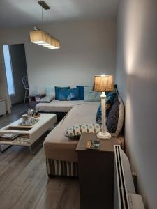 a bedroom with a bed and a table with a lamp at Puces de Vanves in Malakoff