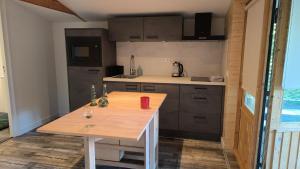 a kitchen with a wooden table in a room at 't klompenkot in Middelburg +2 photos